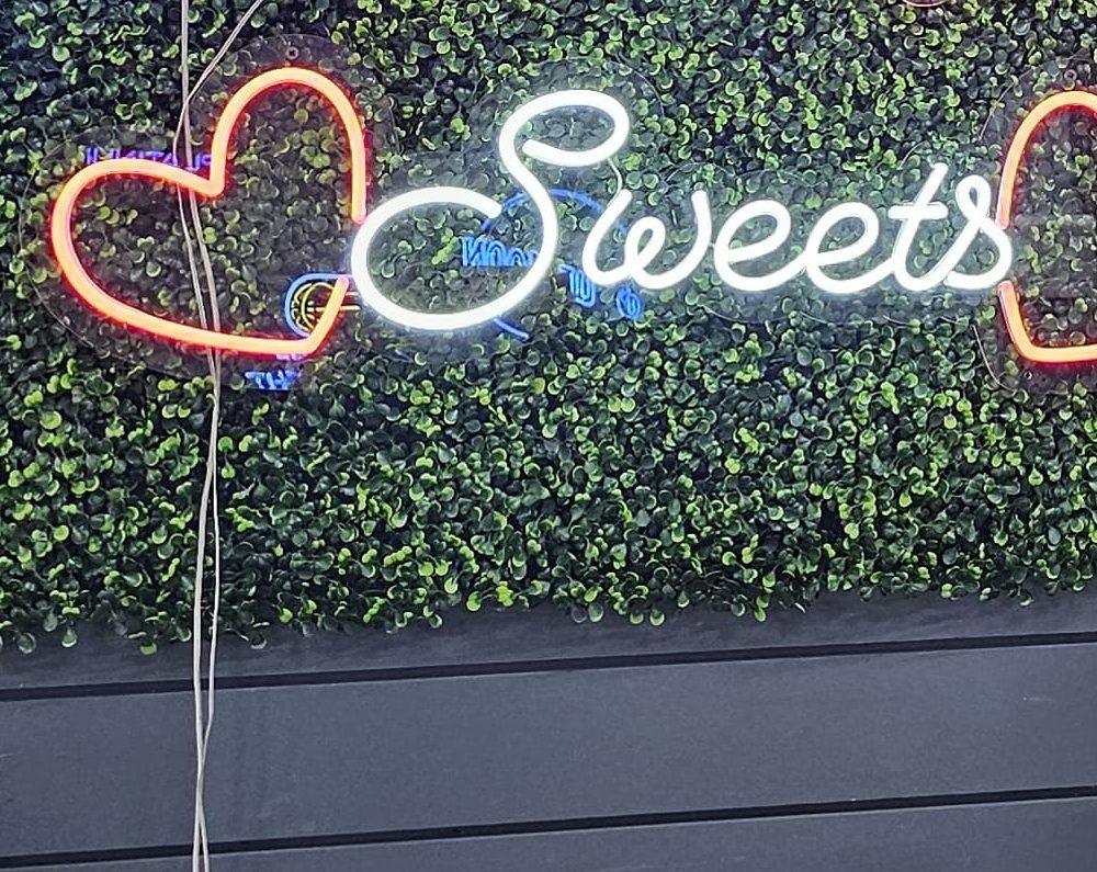 Sweets script neon sign with heart accents, for a dessert table